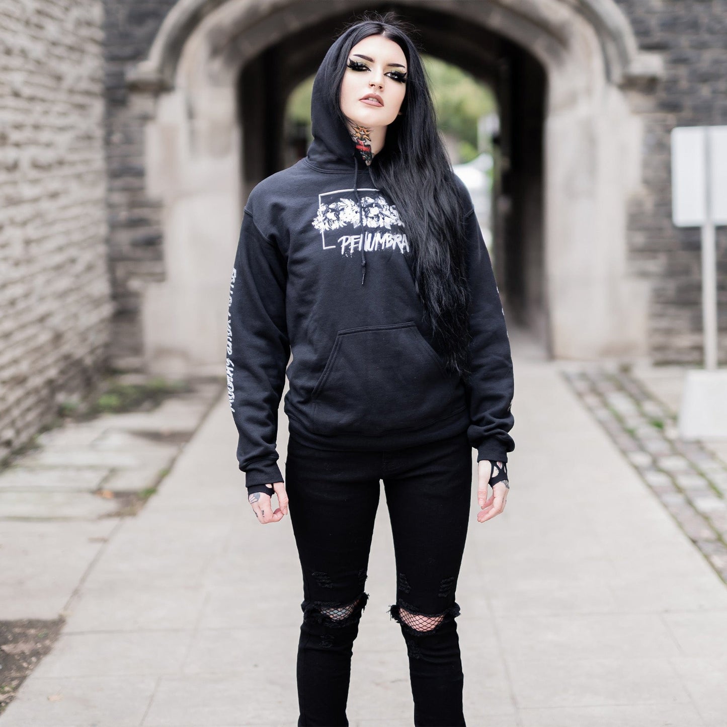 Gothic model wearing the Penumbra Black Hoodie in a Victorian setting, capturing the essence of dark macabre fashion.