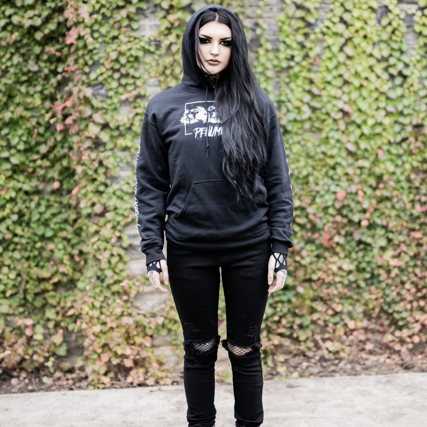 Gothic model wearing the Penumbra Black Hoodie in a Victorian setting, capturing the essence of dark macabre fashion.