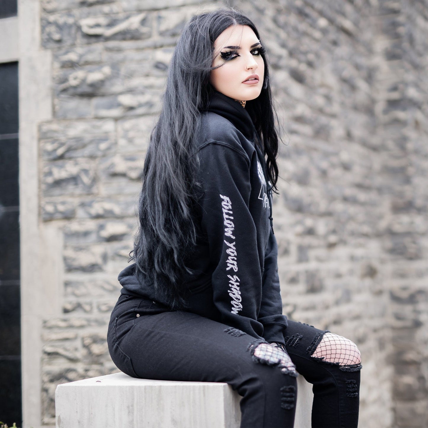 Gothic model wearing the Penumbra Black Hoodie in a Victorian setting, capturing the essence of dark macabre fashion.