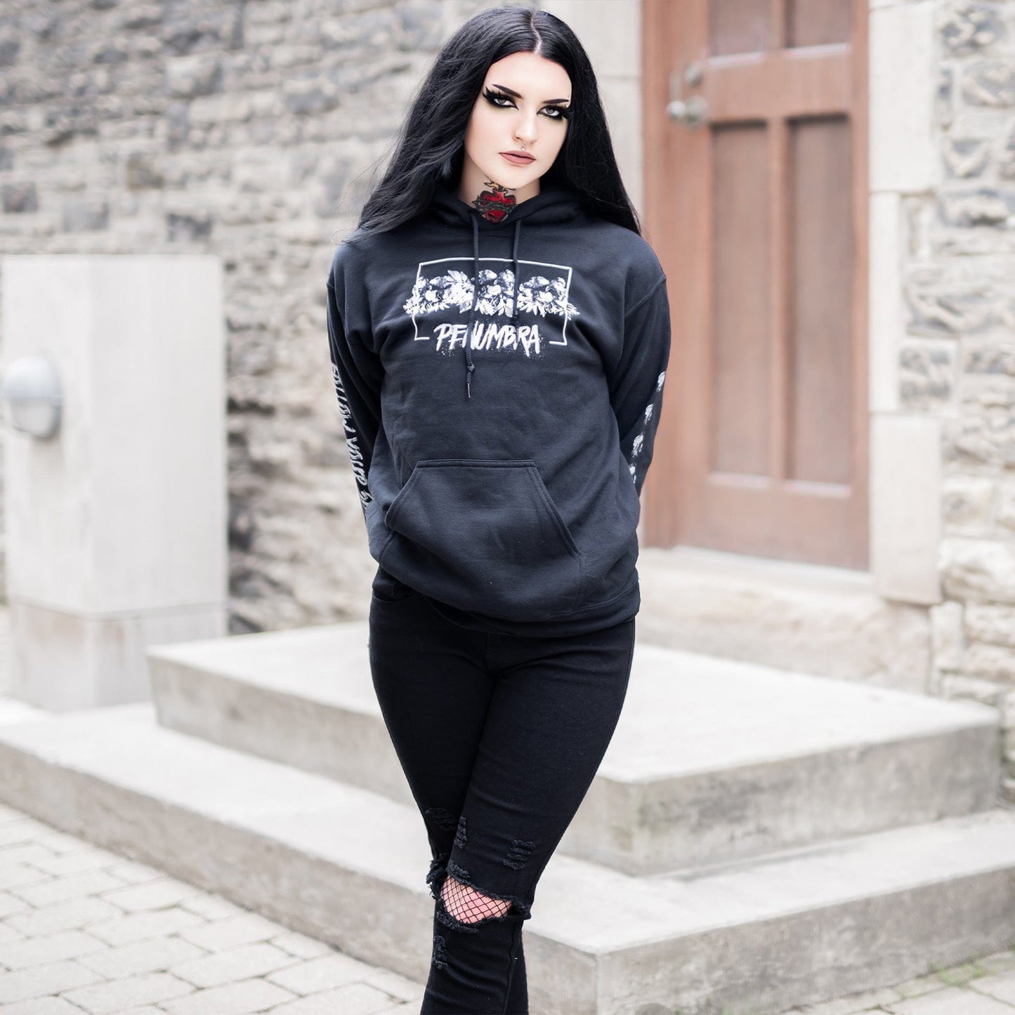 Gothic model wearing the Penumbra Black Hoodie in a Victorian setting, capturing the essence of dark macabre fashion.
