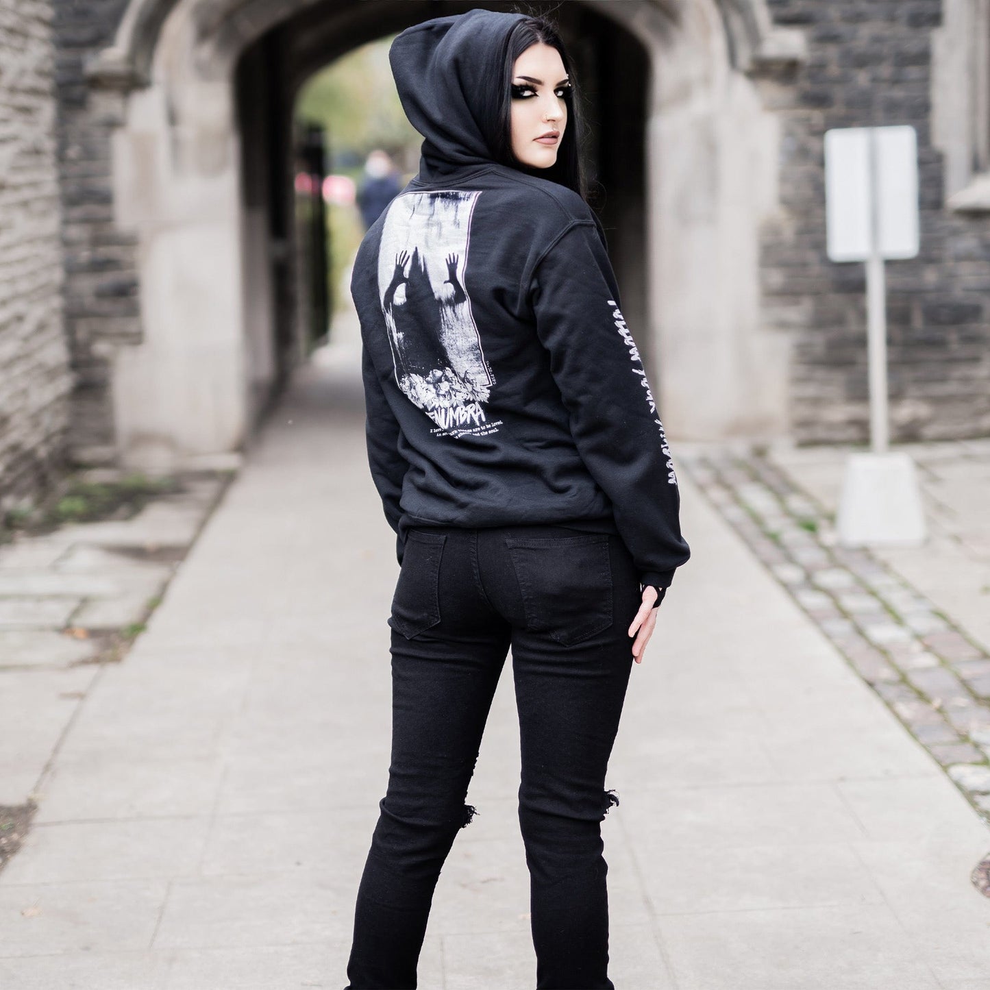 Gothic model wearing the Penumbra Black Hoodie in a Victorian setting, capturing the essence of dark macabre fashion.