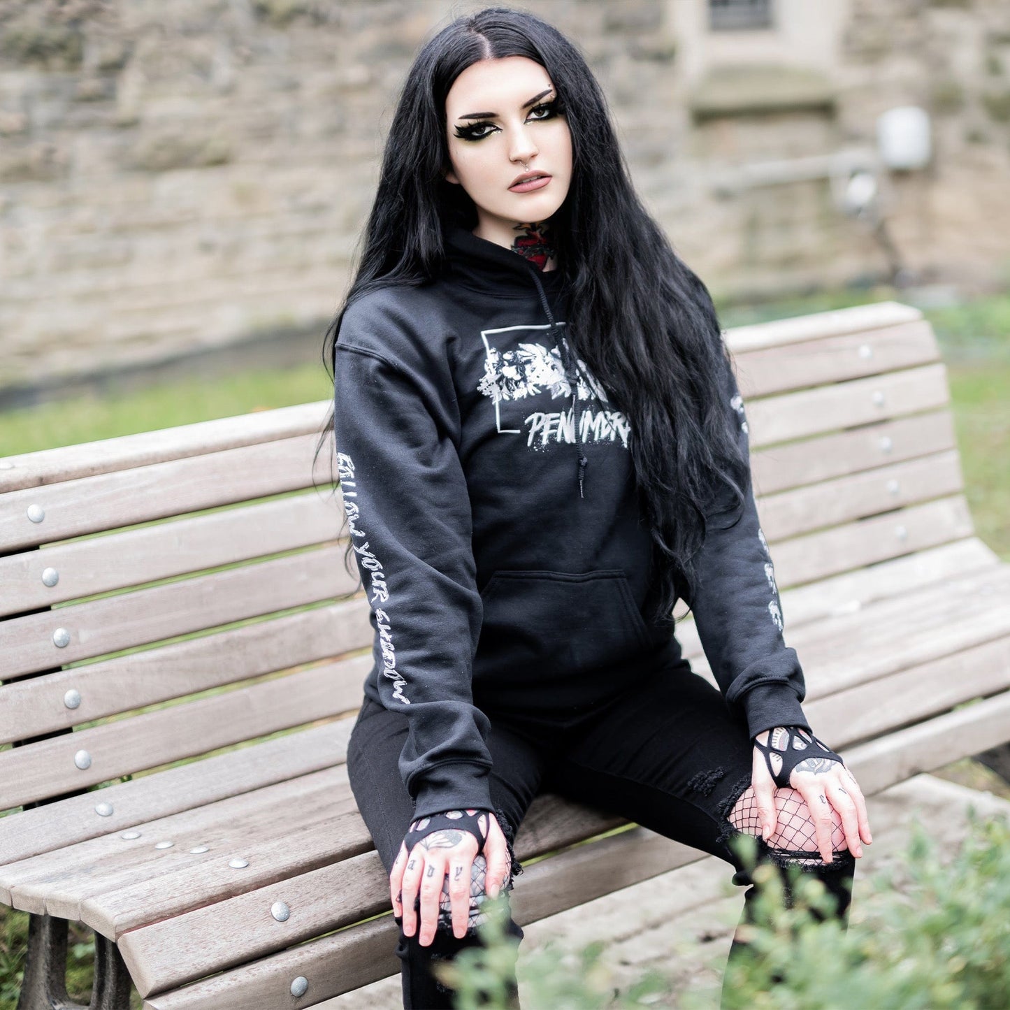 Gothic model wearing the Penumbra Black Hoodie in a Victorian setting, capturing the essence of dark macabre fashion.