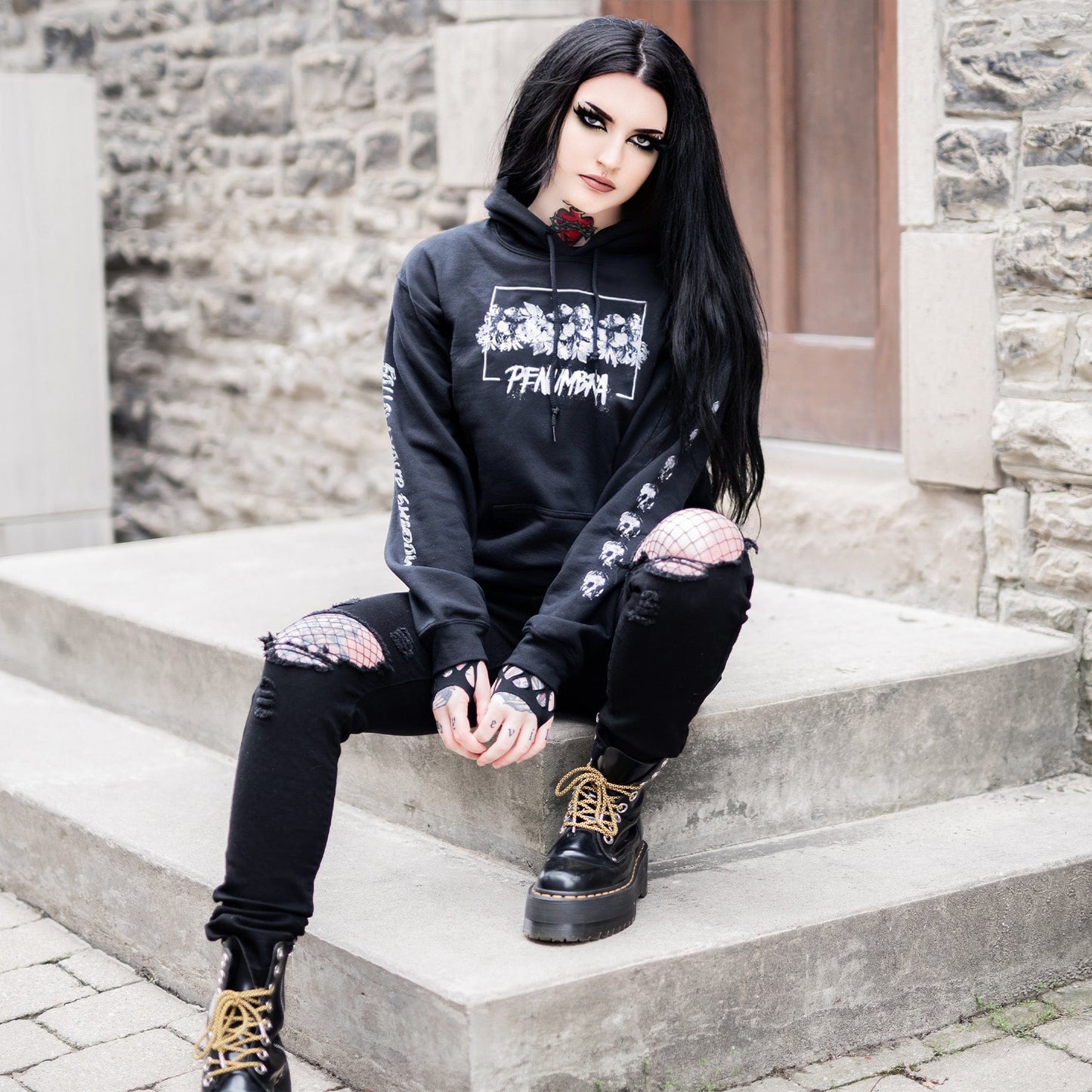 Gothic model wearing the Penumbra Black Hoodie in a Victorian setting, capturing the essence of dark macabre fashion.