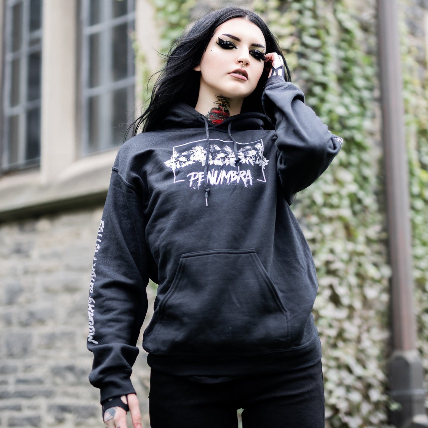 Gothic model wearing the Penumbra Black Hoodie in a Victorian setting, capturing the essence of dark macabre fashion.