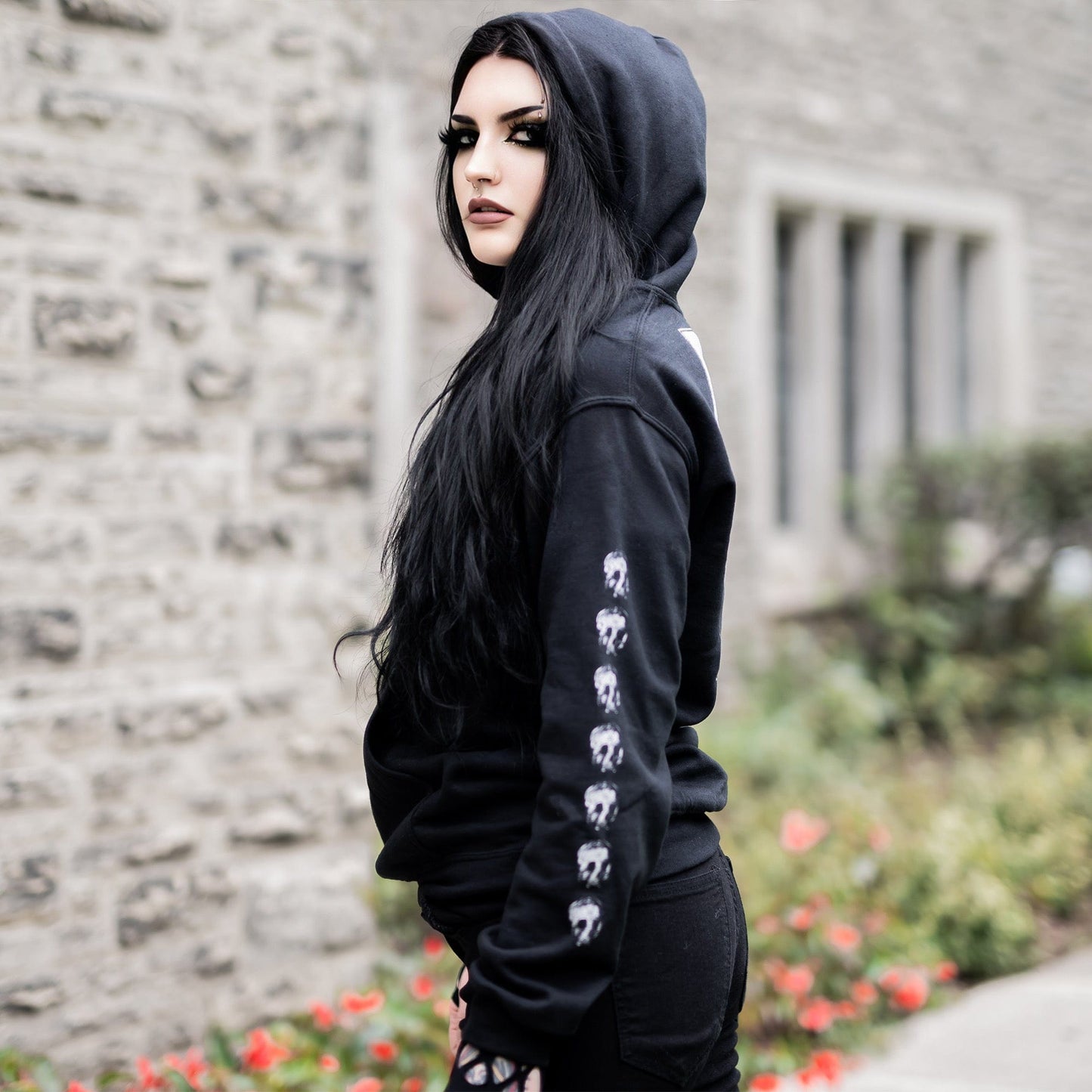 Gothic model wearing the Penumbra Black Hoodie in a Victorian setting, capturing the essence of dark macabre fashion.