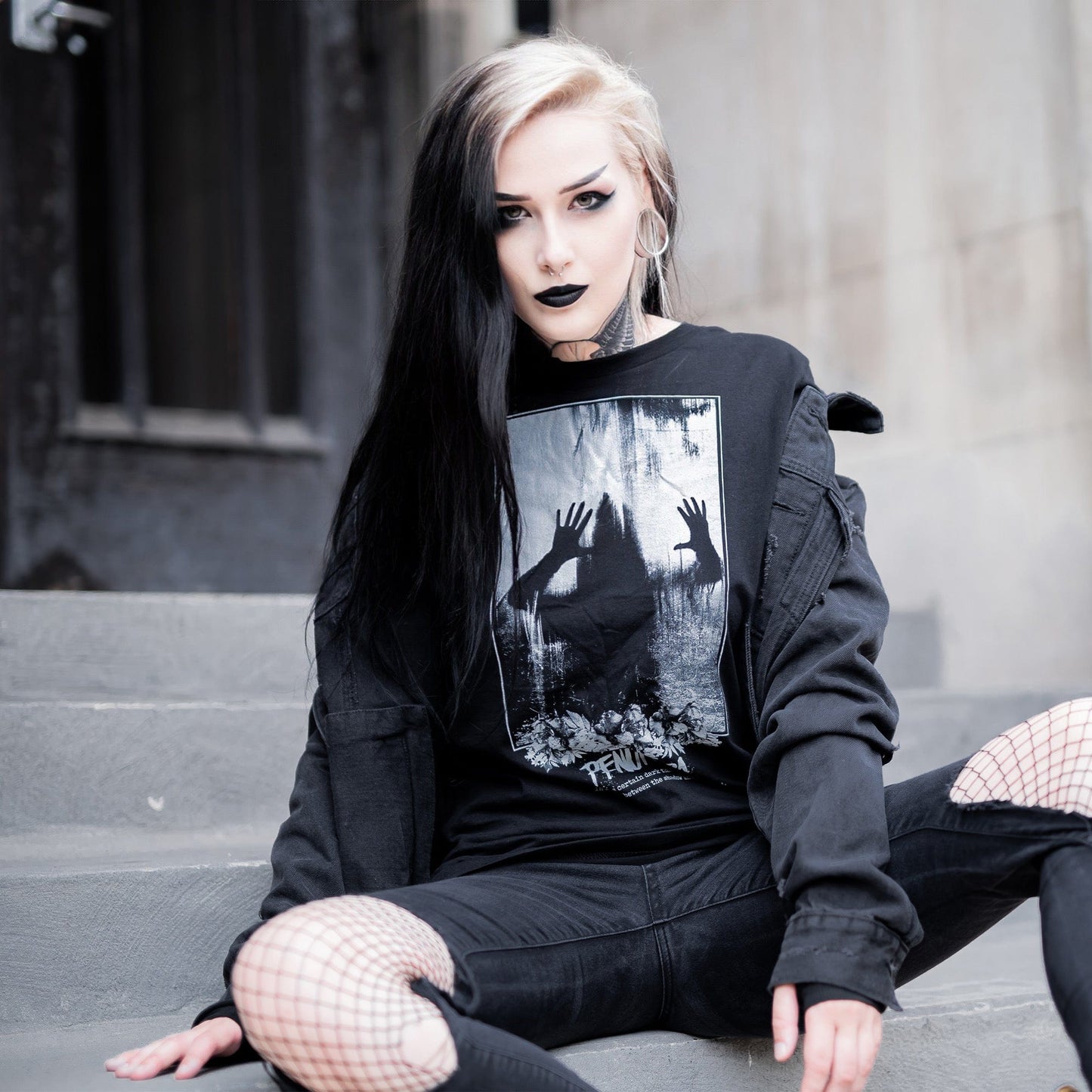 Gothic model wearing the Penumbra Graphic T-Shirt in a Victorian setting, capturing the essence of dark macabre fashion.