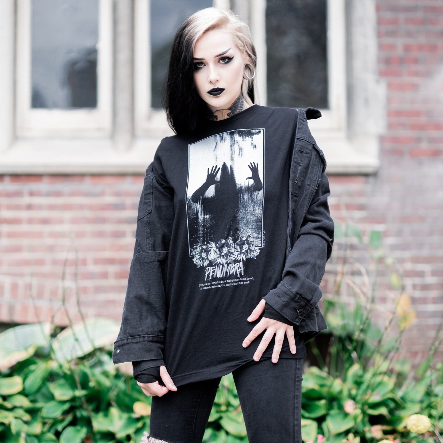 Gothic model wearing the Penumbra Graphic T-Shirt in a Victorian setting, capturing the essence of dark macabre fashion.