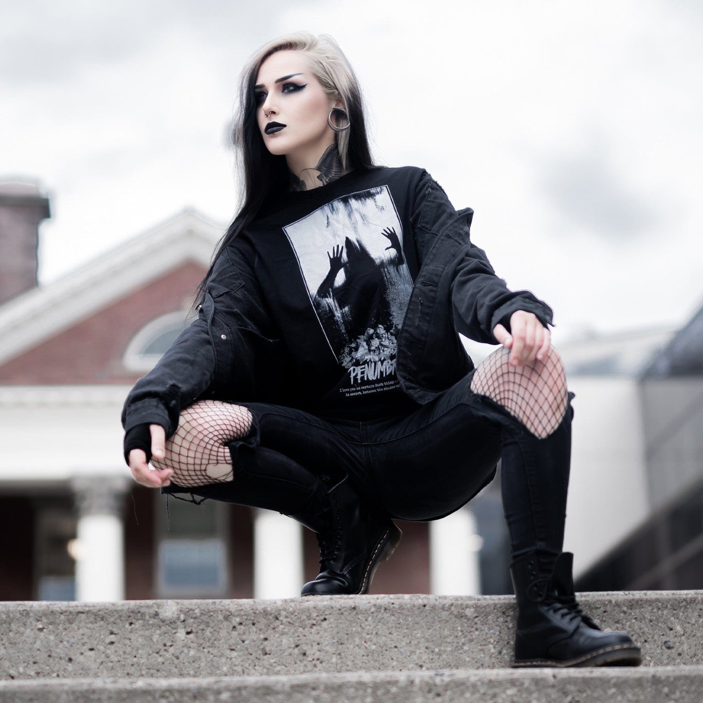Gothic model wearing the Penumbra Graphic T-Shirt in a Victorian setting, capturing the essence of dark macabre fashion.
