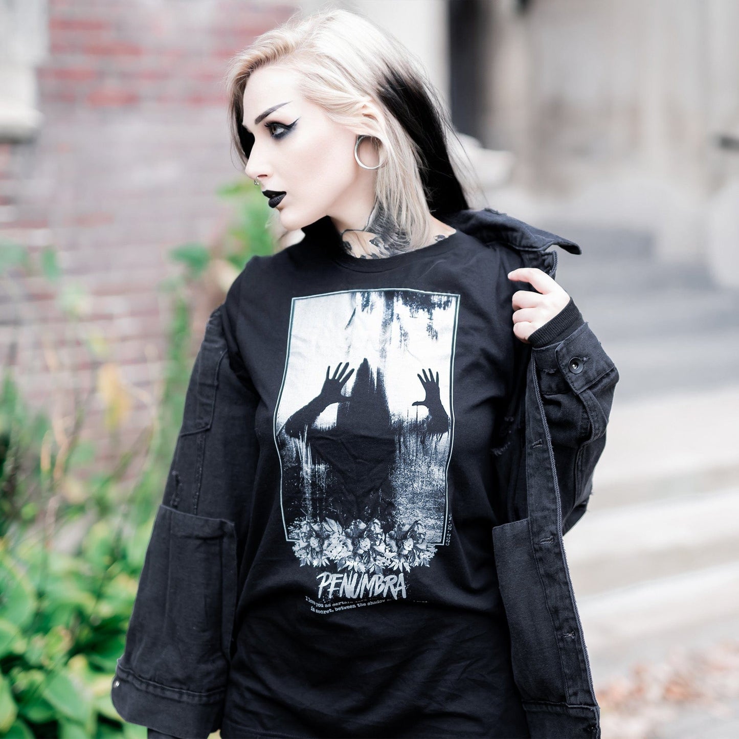 Gothic model wearing the Penumbra Graphic T-Shirt in a Victorian setting, capturing the essence of dark macabre fashion.