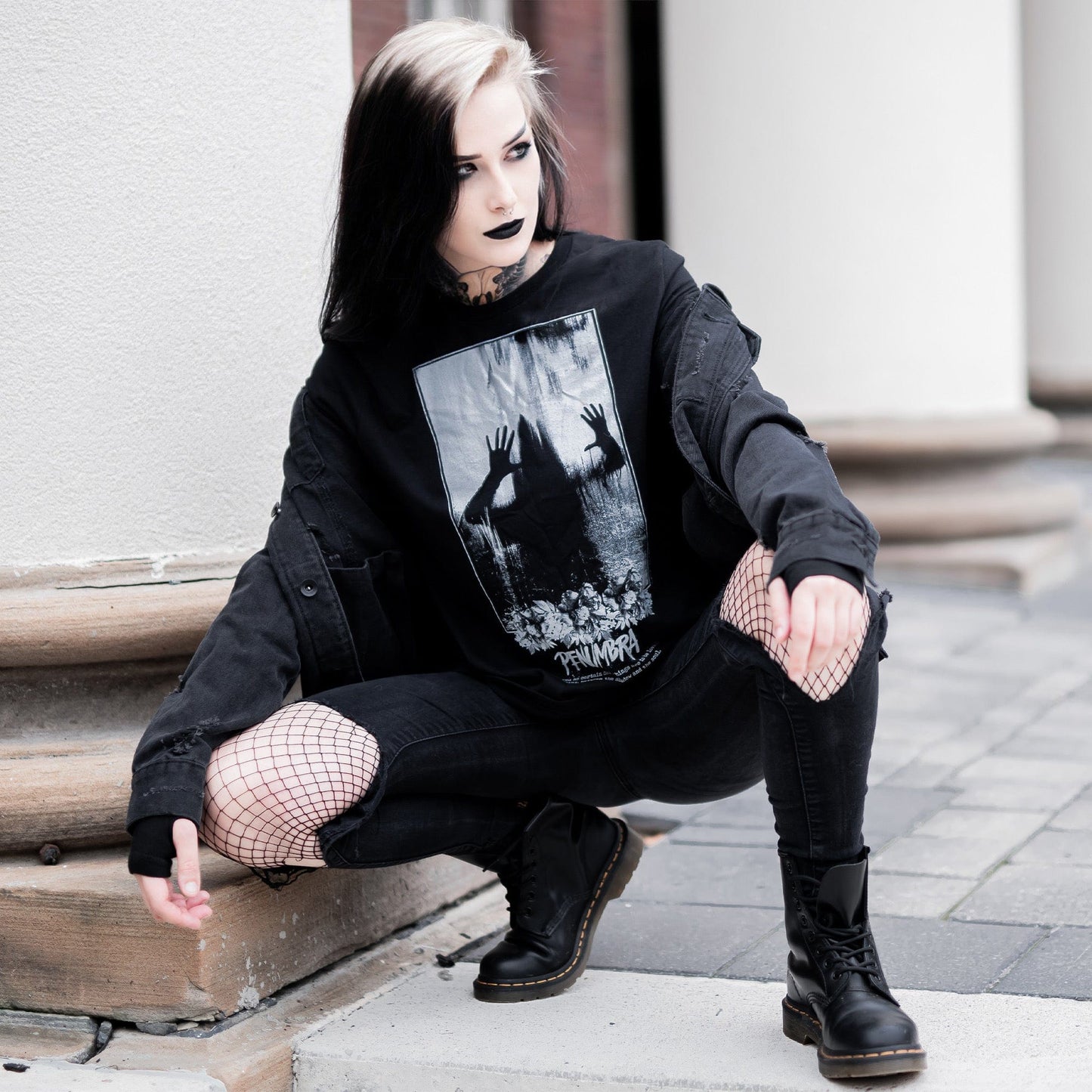 Gothic model wearing the Penumbra Graphic T-Shirt in a Victorian setting, capturing the essence of dark macabre fashion.