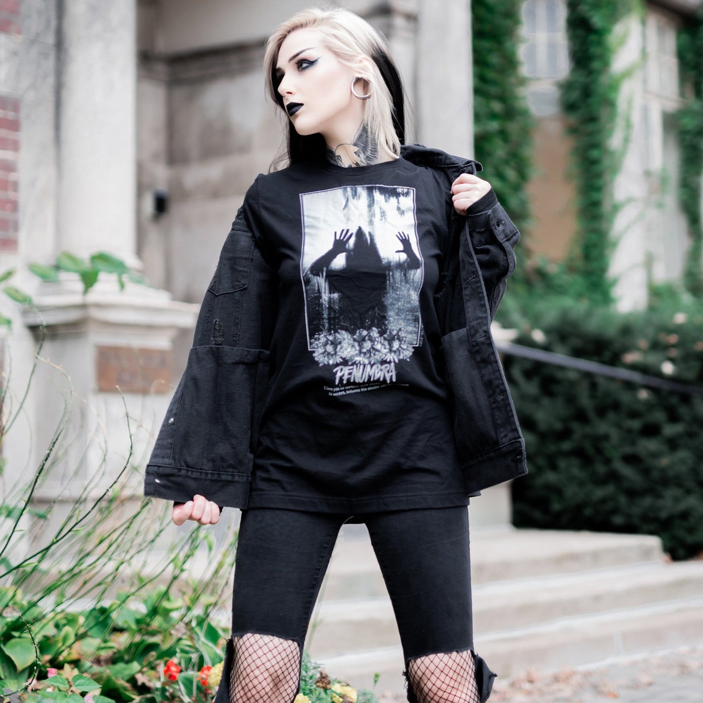 Gothic model wearing the Penumbra Graphic T-Shirt in a Victorian setting, capturing the essence of dark macabre fashion.