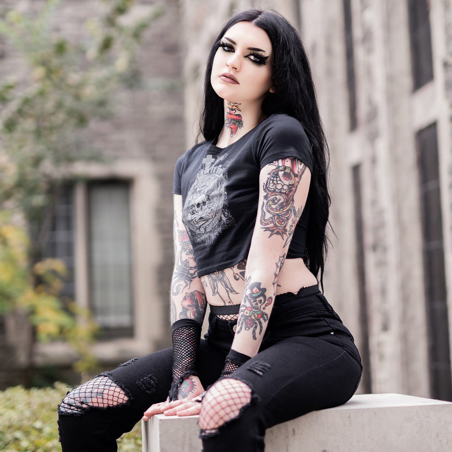 Goth model wearing the Revivisco Graphic Crop Top, showcasing the ancient sigil design and dark aesthetic appeal.