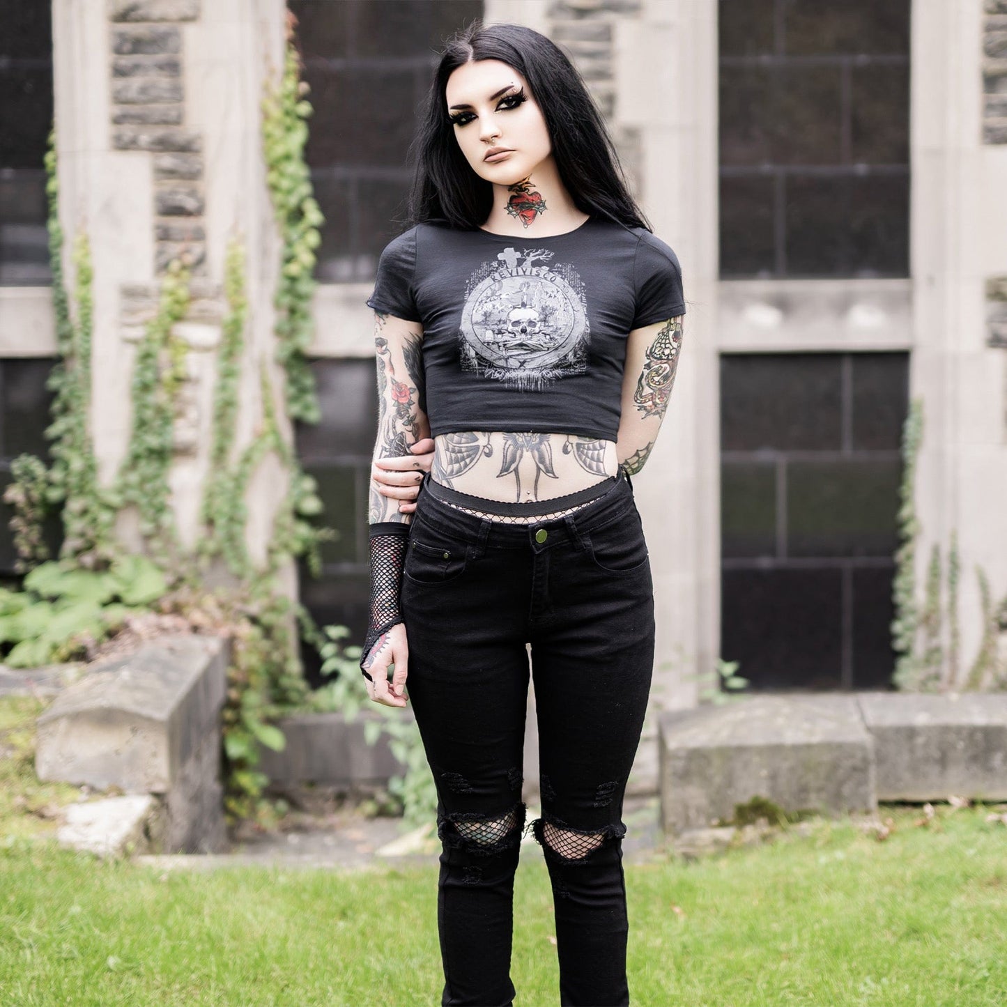 Goth model wearing the Revivisco Graphic Crop Top, showcasing the ancient sigil design and dark aesthetic appeal.