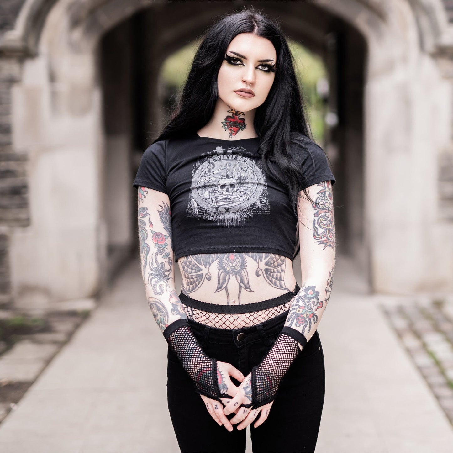 Goth model wearing the Revivisco Graphic Crop Top, showcasing the ancient sigil design and dark aesthetic appeal.