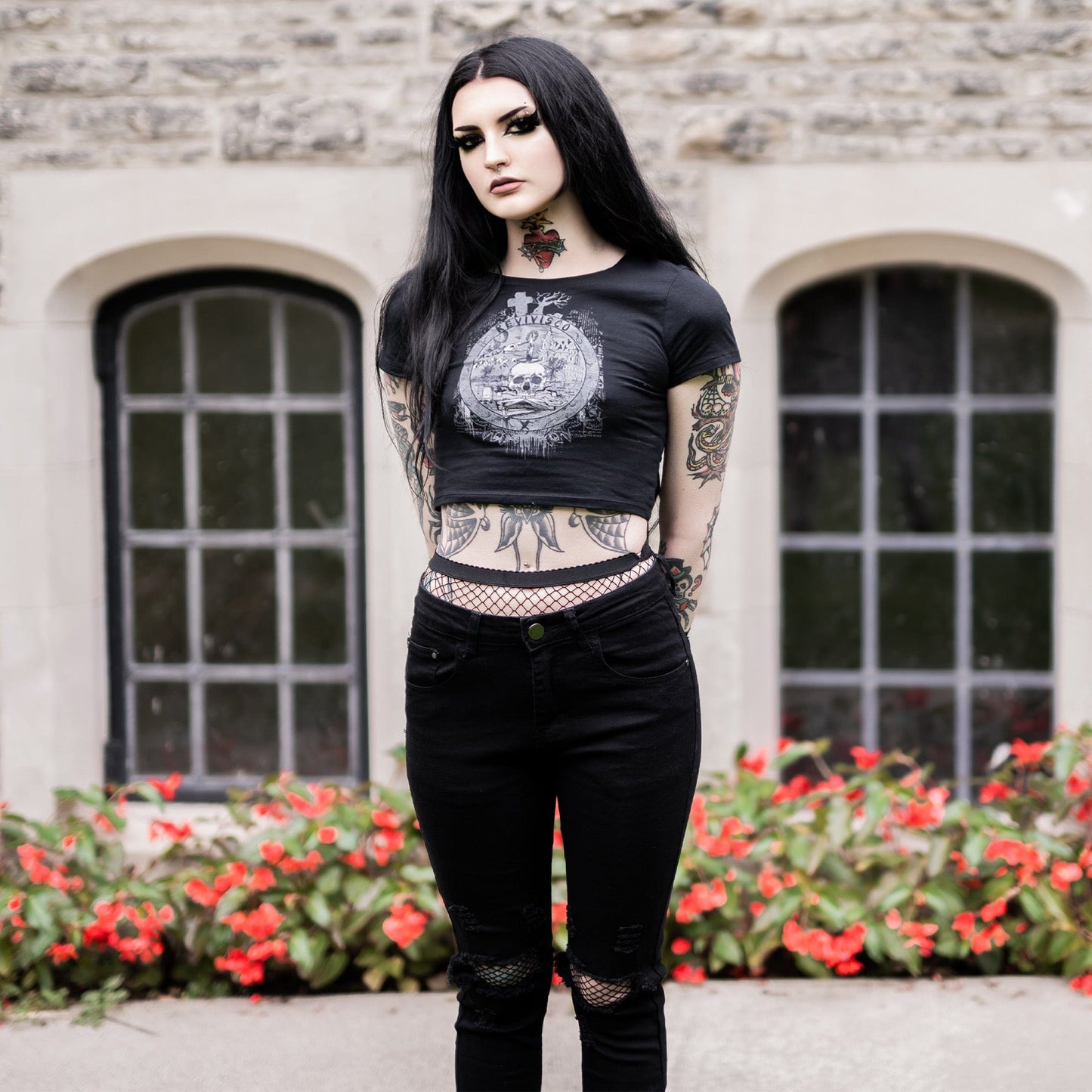 Goth model wearing the Revivisco Graphic Crop Top, showcasing the ancient sigil design and dark aesthetic appeal.