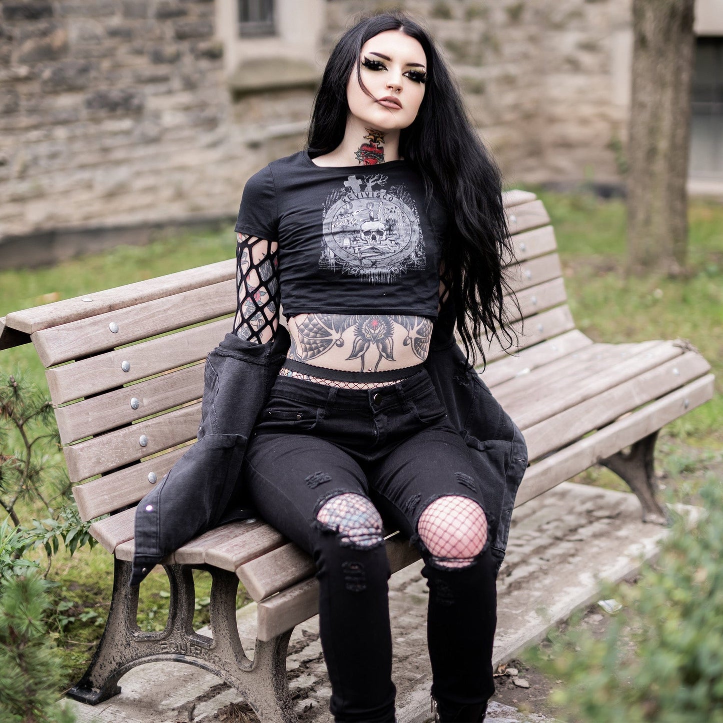 Goth model wearing the Revivisco Graphic Crop Top, showcasing the ancient sigil design and dark aesthetic appeal.