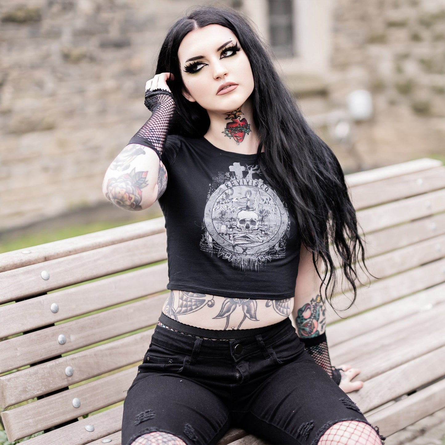 Goth model wearing the Revivisco Graphic Crop Top, showcasing the ancient sigil design and dark aesthetic appeal.