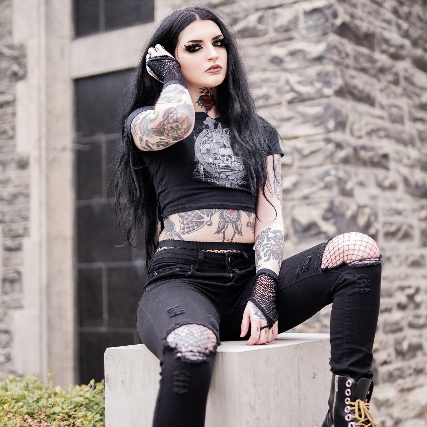 Goth model wearing the Revivisco Graphic Crop Top, showcasing the ancient sigil design and dark aesthetic appeal.