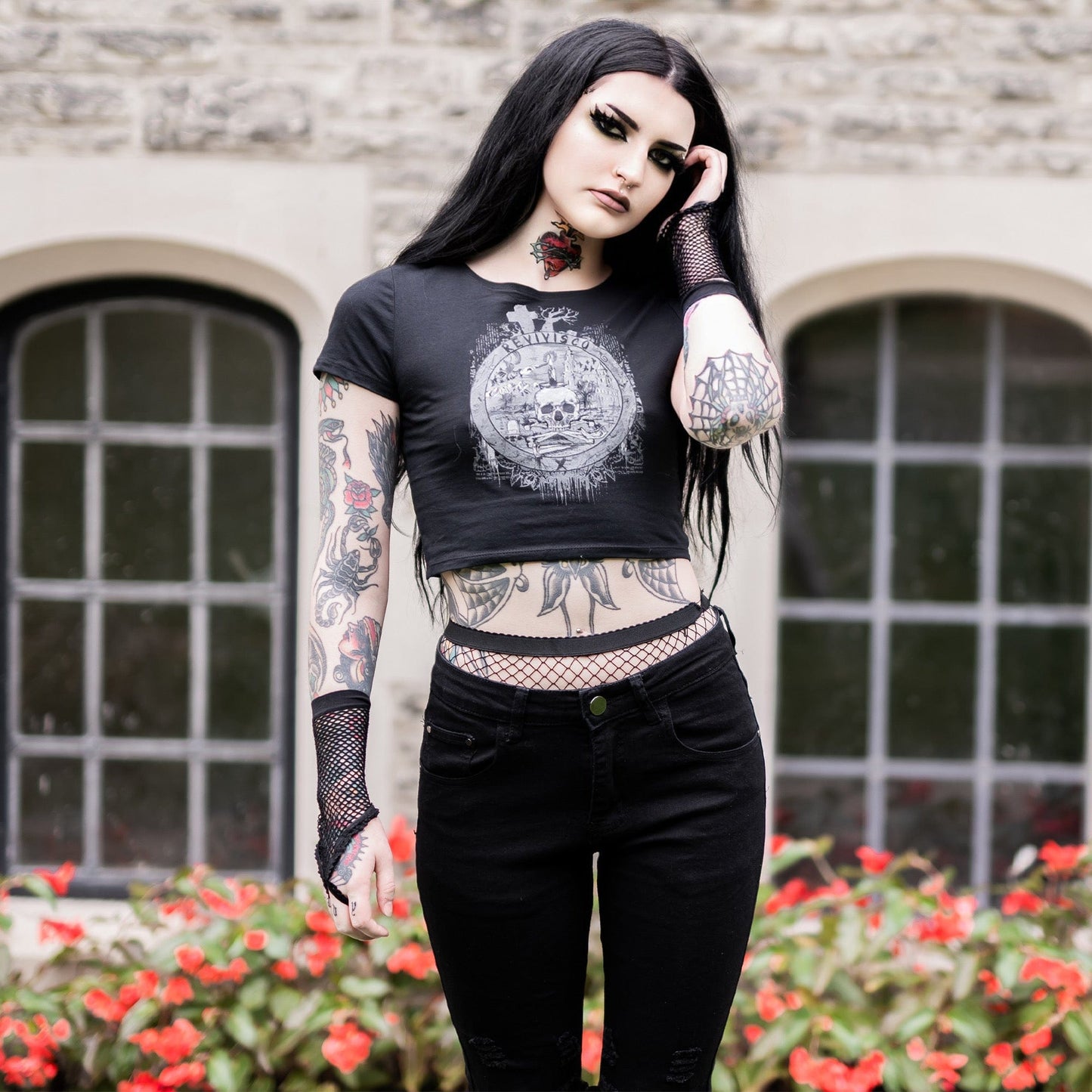 Goth model wearing the Revivisco Graphic Crop Top, showcasing the ancient sigil design and dark aesthetic appeal.
