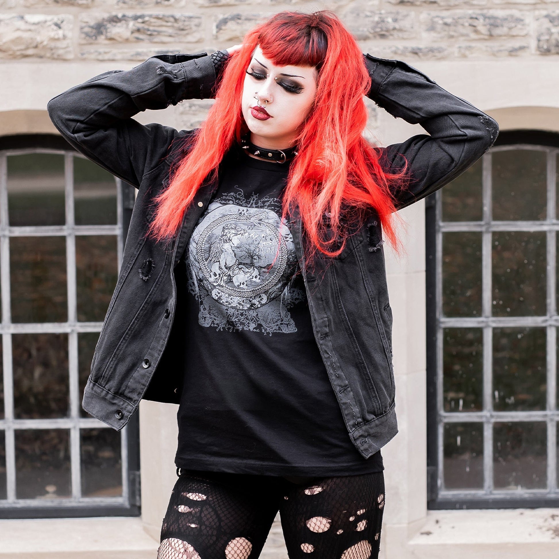 Goth model wearing the Eternal Echoes Graphic T-Shirt with Ouroboros and Divine Child design in a Victorian setting.