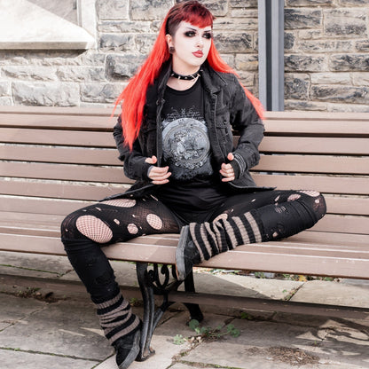 Goth model wearing the Eternal Echoes Graphic T-Shirt with Ouroboros and Divine Child design in a Victorian setting.