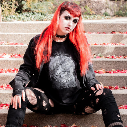 Goth model wearing the Eternal Echoes Graphic T-Shirt with Ouroboros and Divine Child design in a Victorian setting.