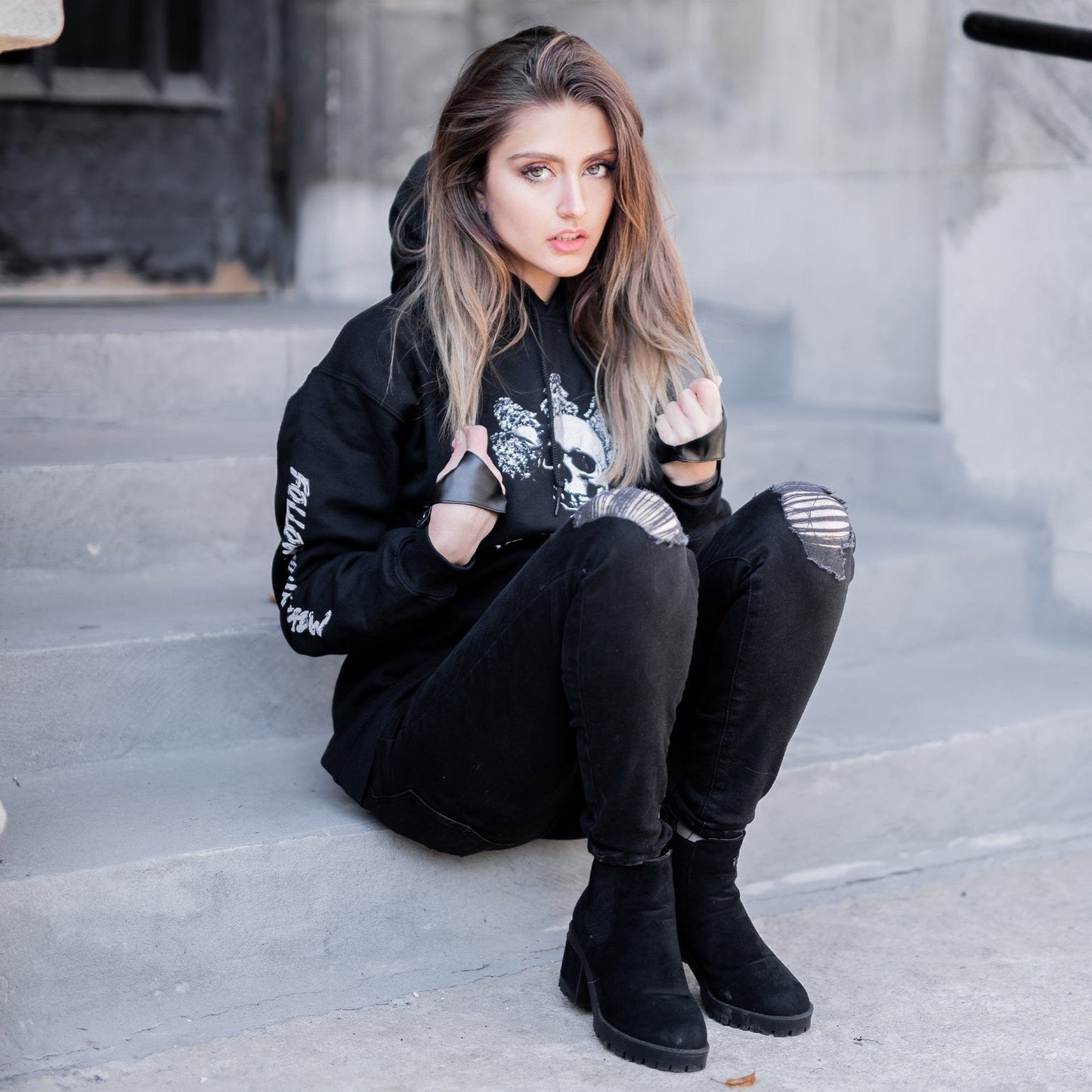 Gothic model wearing the Follow Your Shadow: Mr. Serial Killer Macabre Graphic Black Hoodie in a Victorian setting, embodying dark macabre fashion