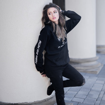 Gothic model wearing the Follow Your Shadow: Mr. Serial Killer Macabre Graphic Black Hoodie in a Victorian setting, embodying dark macabre fashion