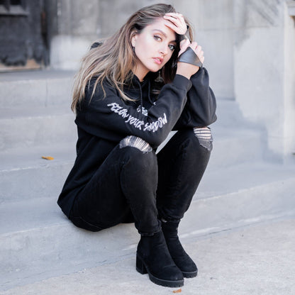 Gothic model wearing the Follow Your Shadow: Mr. Serial Killer Macabre Graphic Black Hoodie in a Victorian setting, embodying dark macabre fashion