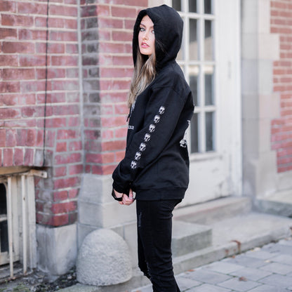 Gothic model wearing the Follow Your Shadow: Mr. Serial Killer Macabre Graphic Black Hoodie in a Victorian setting, embodying dark macabre fashion