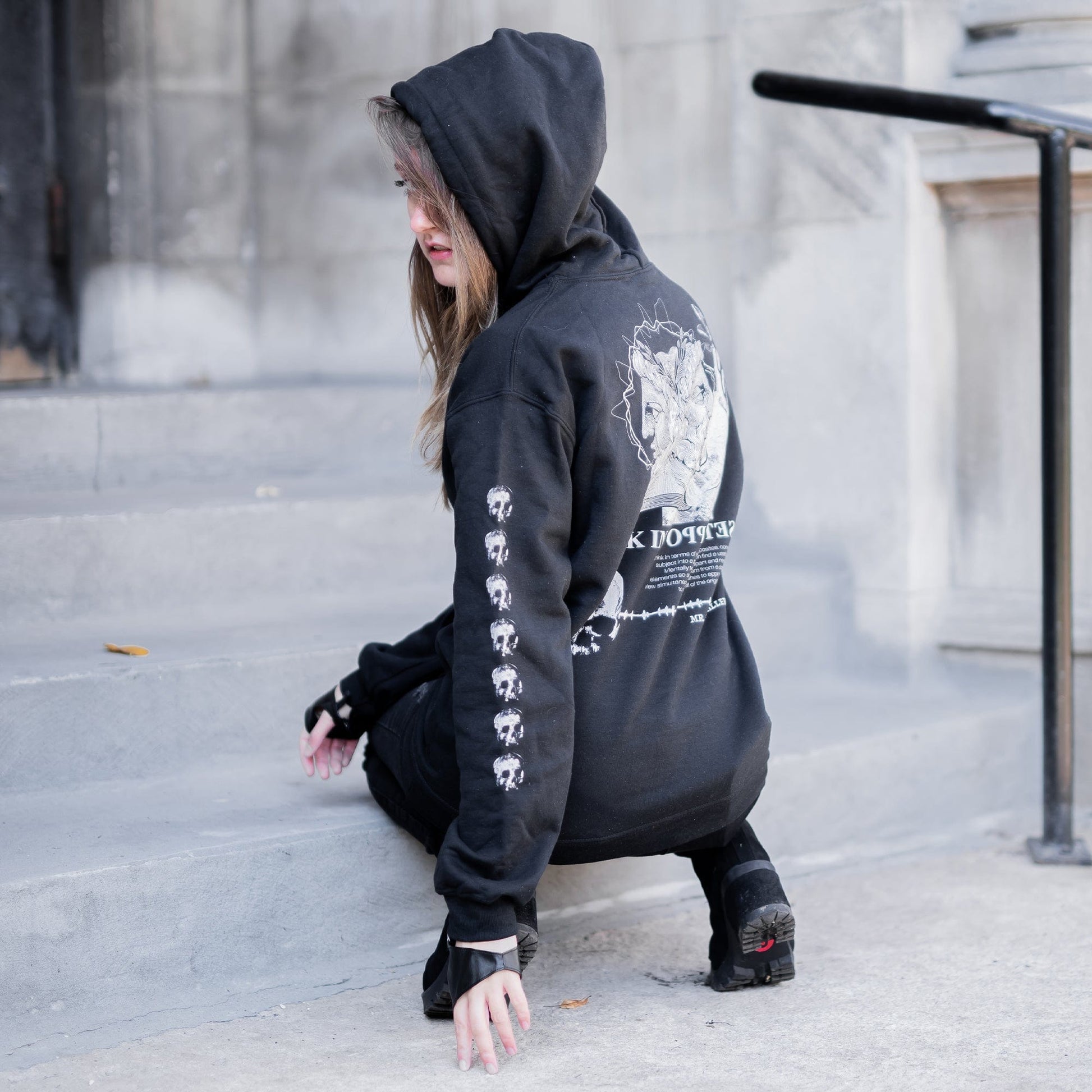 Gothic model wearing the Follow Your Shadow: Mr. Serial Killer Macabre Graphic Black Hoodie in a Victorian setting, embodying dark macabre fashion