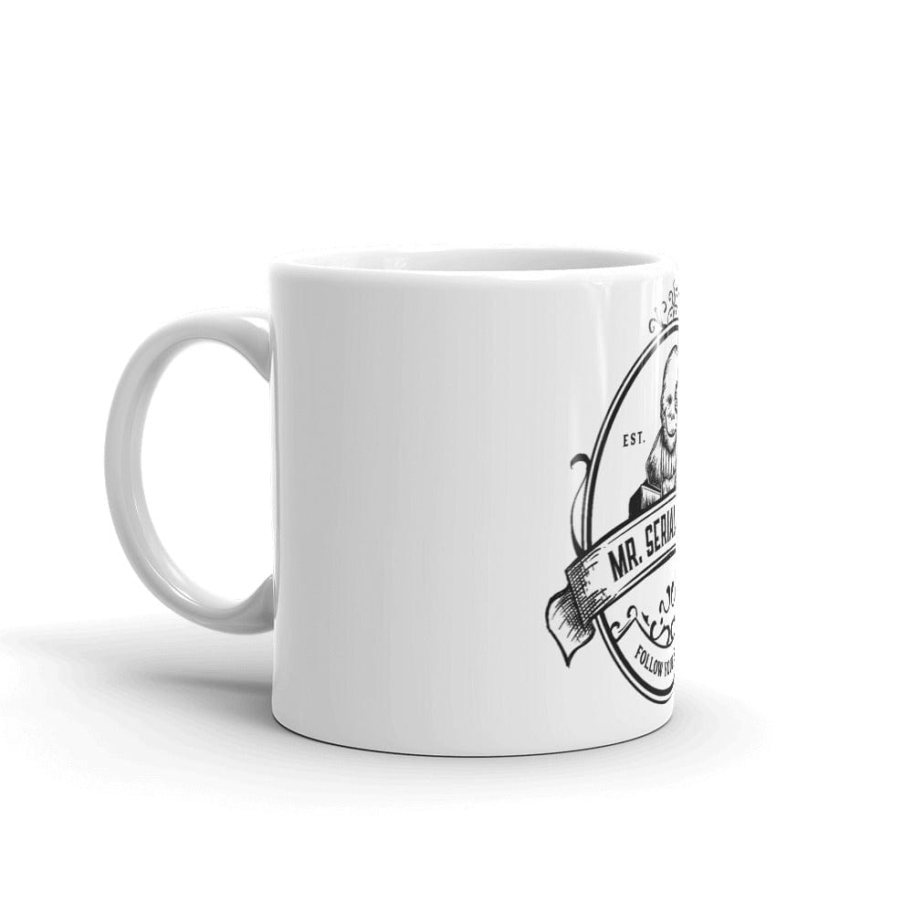 Mockup of the 'Follow Your Shadow' coffee mug featuring Mr. Serial Killer with a custom illustration and show logo, available in glossy white with black print, in 11oz and 15oz sizes.