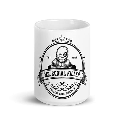 Mockup of the 'Follow Your Shadow' coffee mug featuring Mr. Serial Killer with a custom illustration and show logo, available in glossy white with black print, in 11oz and 15oz sizes.