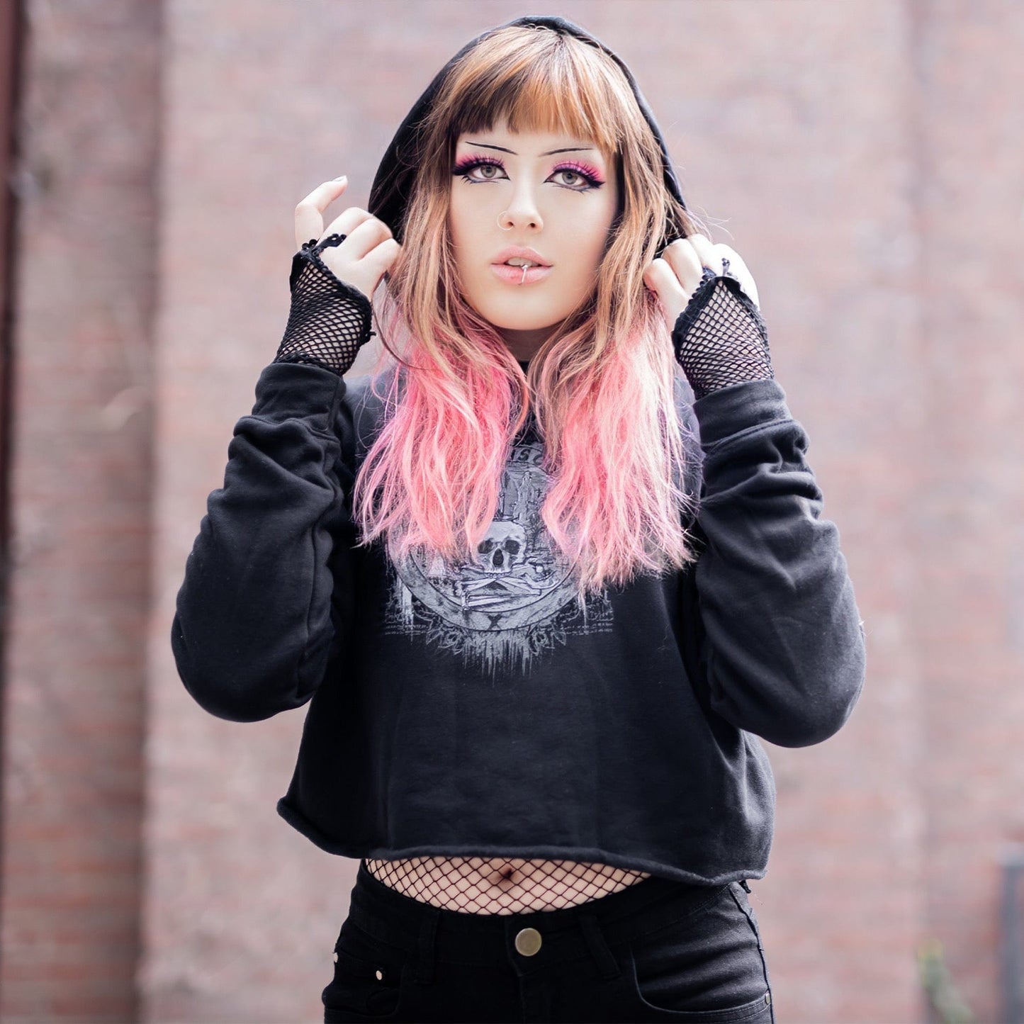 Goth model wearing the Revivisco Graphic Crop Hoodie, showcasing the ancient sigil design and dark aesthetic appeal.