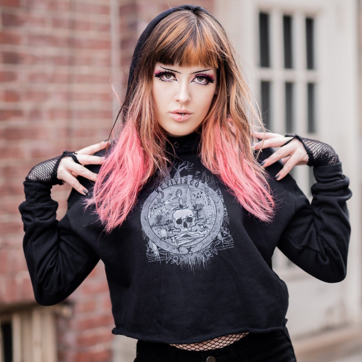 Goth model wearing the Revivisco Graphic Crop Hoodie, showcasing the ancient sigil design and dark aesthetic appeal.