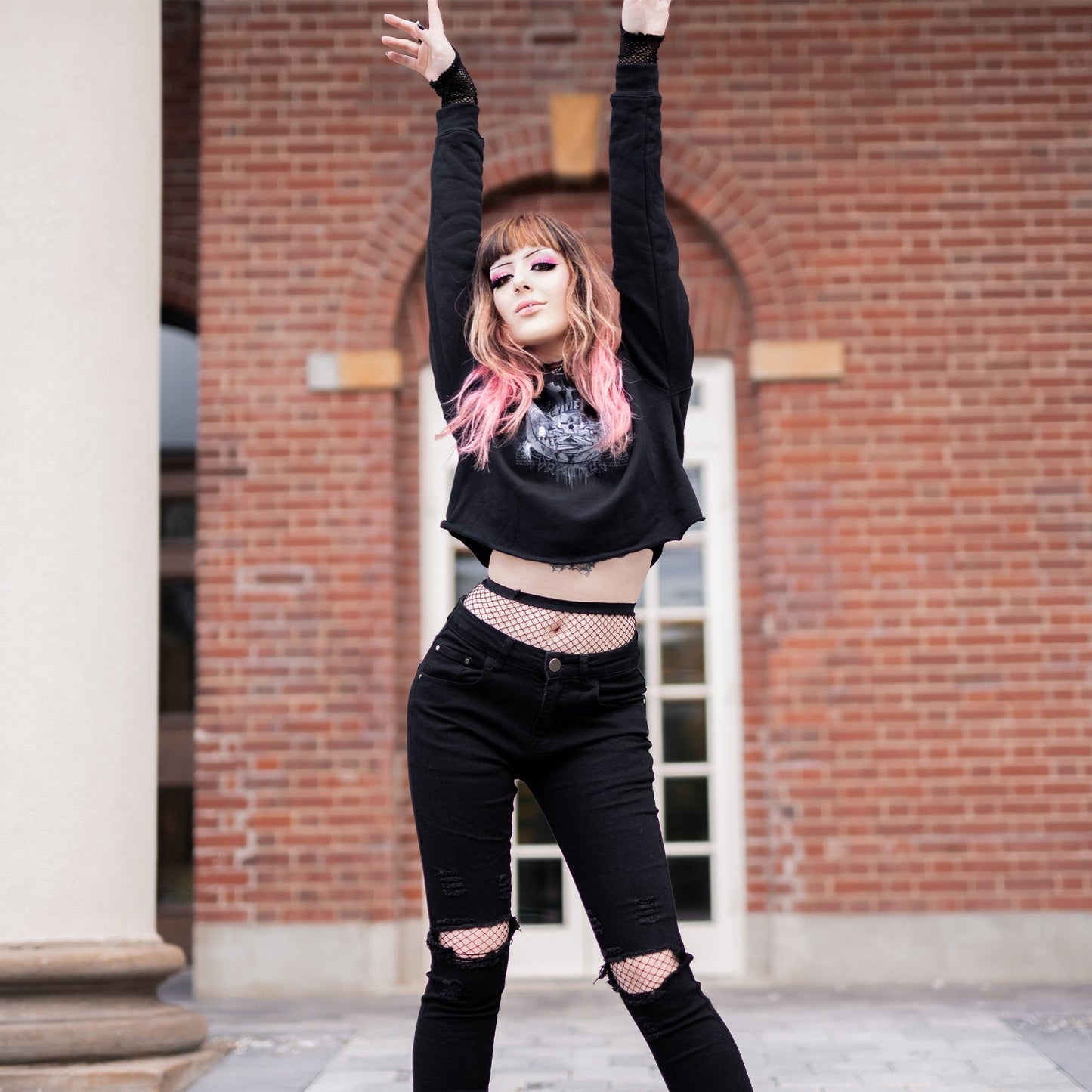 Goth model wearing the Revivisco Graphic Crop Hoodie, showcasing the ancient sigil design and dark aesthetic appeal.