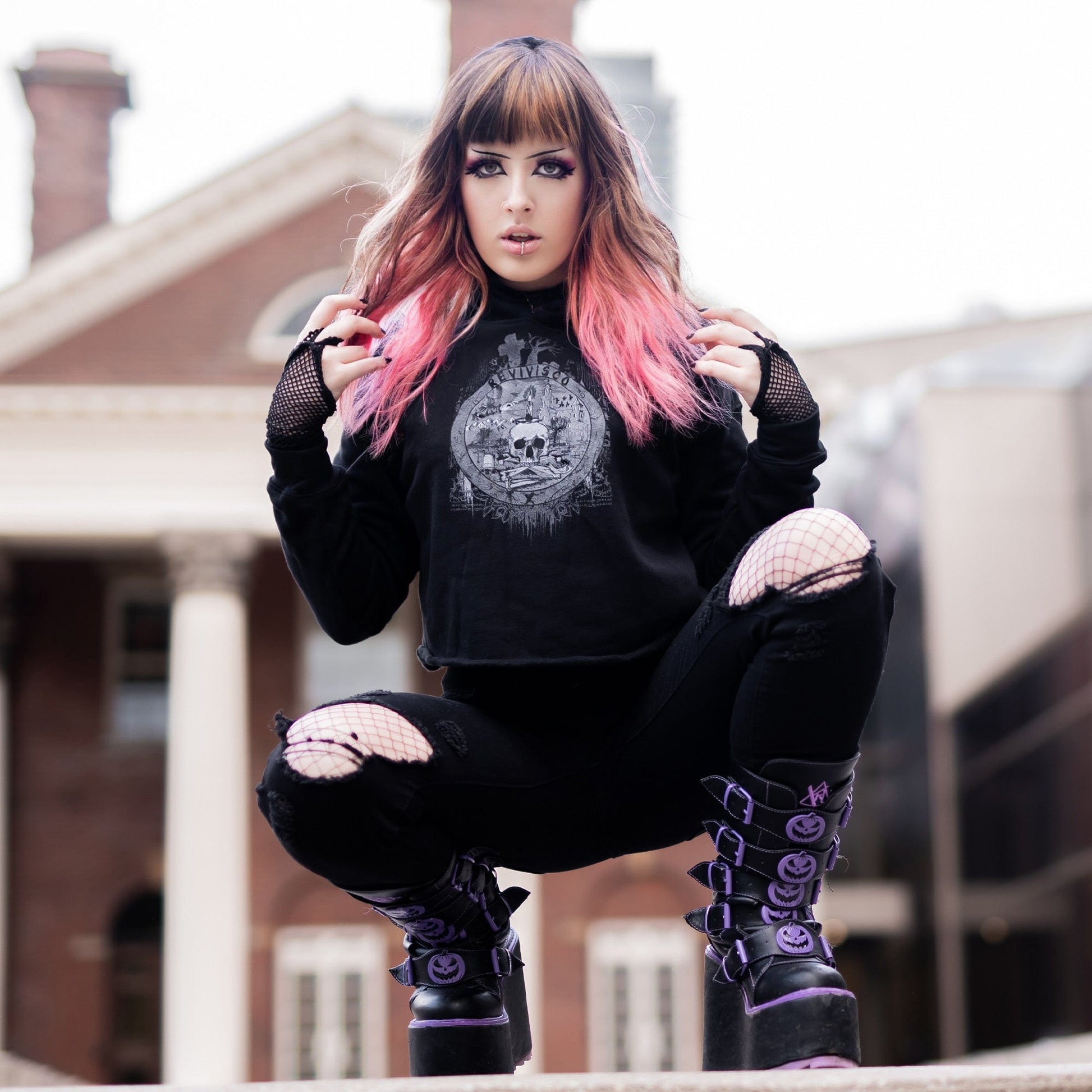 Goth model wearing the Revivisco Graphic Crop Hoodie, showcasing the ancient sigil design and dark aesthetic appeal.