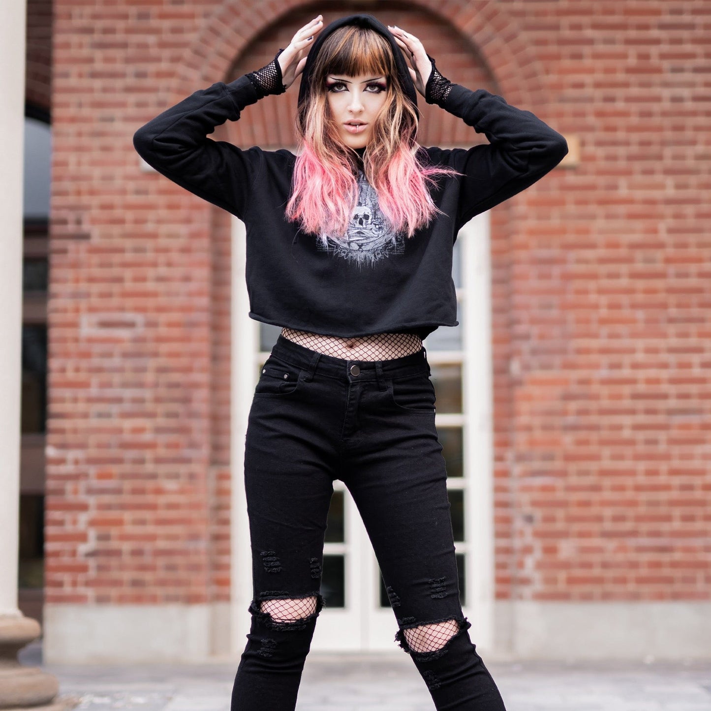 Goth model wearing the Revivisco Graphic Crop Hoodie, showcasing the ancient sigil design and dark aesthetic appeal.